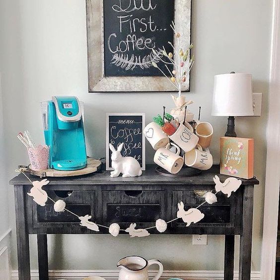 a vintage console with chalkboard drawers, a bunny and egg garland and porcelain bunnies