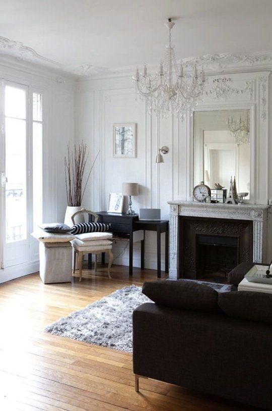 a vintage crystal chandelier and an antique fireplace for a gorgeous French-style living room