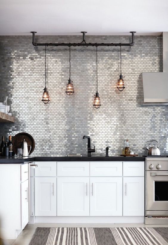 silver tile wall instead of a backsplash is a bold statement in the kitchen