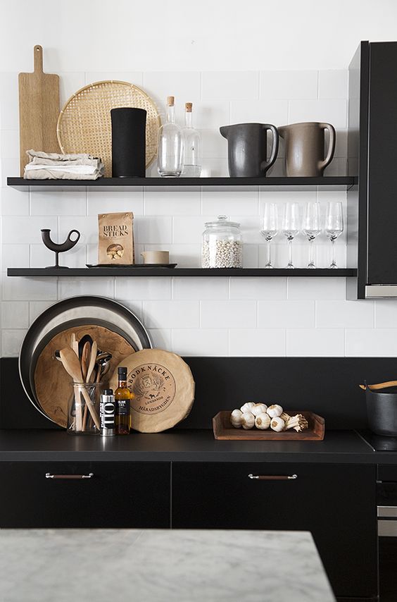 black open shelves match the cabinets and countertops but look less bulky