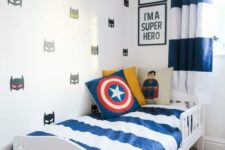 23 super hero wall decals, pillows and some posters add a cool touch to this room