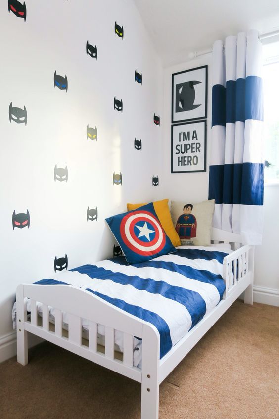 super hero wall decals, pillows and some posters add a cool touch to this room
