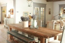 24 a Provence-styled dining room with a reclaimed wooden ceiling with beams and matching furniture