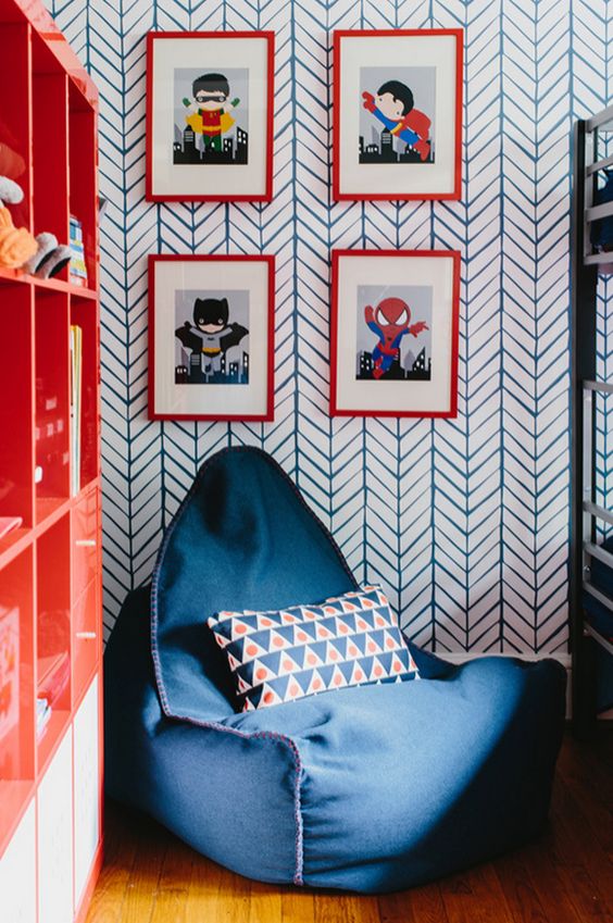 a cool nook with a bean bag chair, colorful super hero posters and a bold bookshelf
