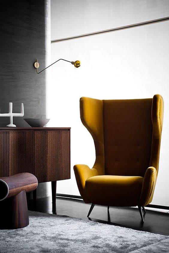 A mustard velvet wingback styled as in the 1950s is ideal for a mid century modern space