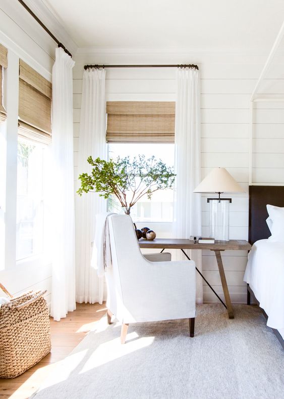 sheer white curtains plus textural Roman shades for a more rustic feel in a farmhouse space