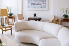 25 a long rounded creamy sectional sofa adds a whimsy touch to this contemporary space