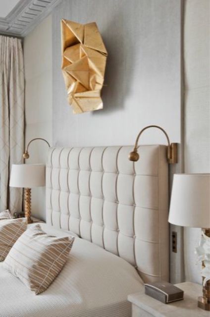 a modern glam geometric sculpture over the bed that echoes lamps