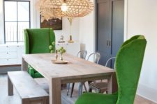25 modern green wingback chairs and a simple wooden dining set contrast creating a unique look