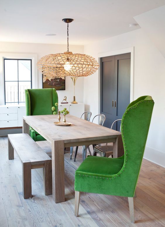 modern green wingback chairs and a simple wooden dining set contrast creating a unique look