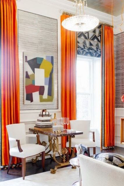 spruce your home with bold curtains like here, orange draperies and geometric print Roman shades