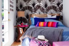 26 a tiny yet colorful bedroom with a printed wall, colorful cube ottomans and bold bedding