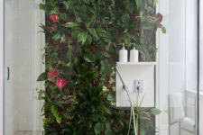 26 a tropical living wall with flowers right in the shower will make you feel outdoors