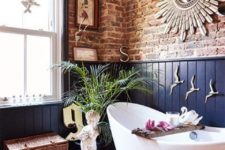 26 an eclectic space with exposed brick and navy wainscoting for a unique and super bold look