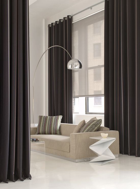 stylish black curtains and an additional semi sheer Roman shade to hide from the sun