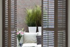 26 wooden shutter folding doors for terrace access is a chic idea to add farmhouse charm to the space
