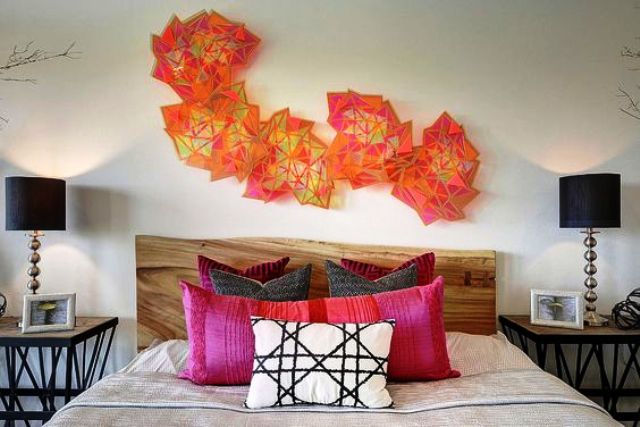 colorful geometric sculptures over the bed make a bold accent