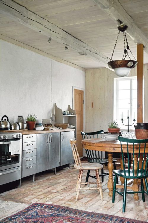 a rustic farmhouse kitchen with freestanding metal cabinets and wooden counters for a softer feel