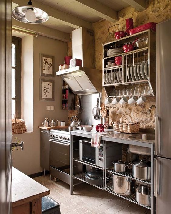 a vintage industrial kitchen with free-standing metal cabinets and much open shelving looks airy