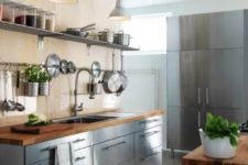 freestanding stainless steel kitchen cabinets with wooden countertops create a cool industrial look