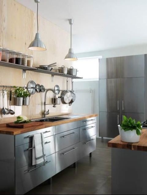 freestanding stainless steel kitchen cabinets with wooden countertops create a cool industrial look