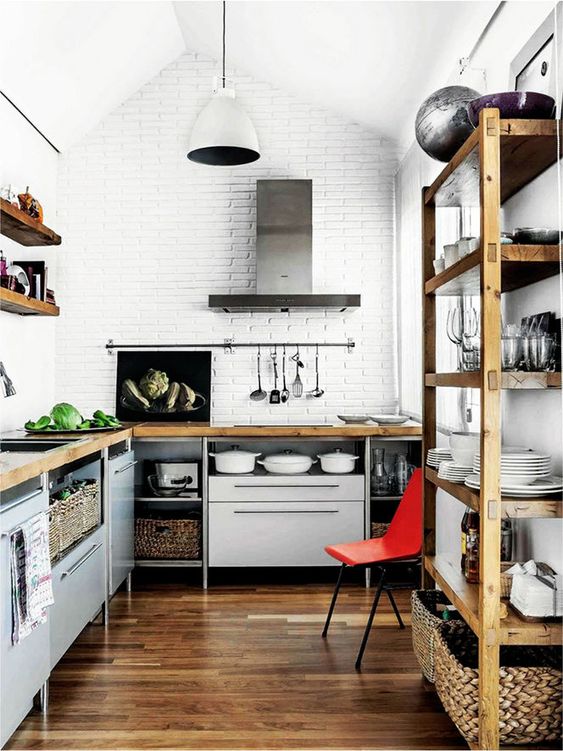 grey kitchen cabinets with metal legs and wooden countertops for a bold and modern kitchen with an industrial feel