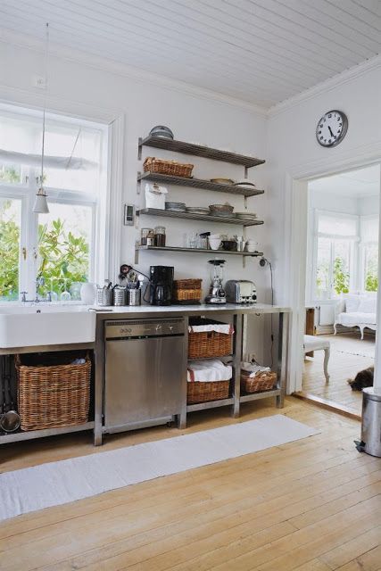 metal cabinets on legs with much open shelving and baskets for storage that soften the look