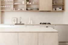 modern light-colored kitchen cabinets on tall thin metal legs for a contemporary and airy feel