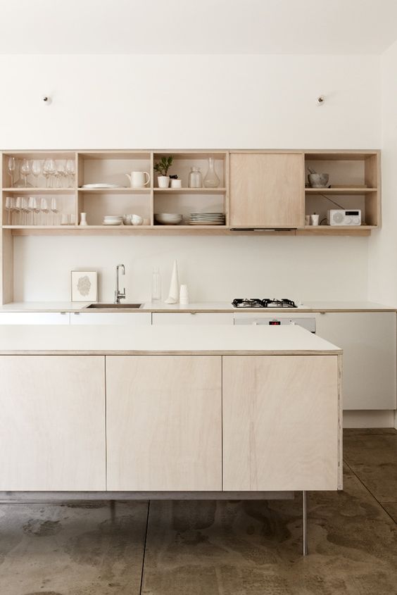 Modern light colored kitchen cabinets on tall thin metal legs for a contemporary and airy feel