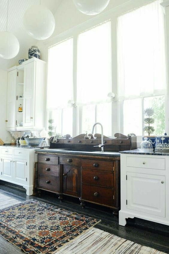 vintage white and dark wood cabinets on legs are used for an eclectic and catchy kitchen look