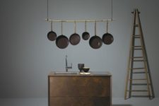 01 Ceragino kitchen is done with an oxidized metal finish and features an additional shelf