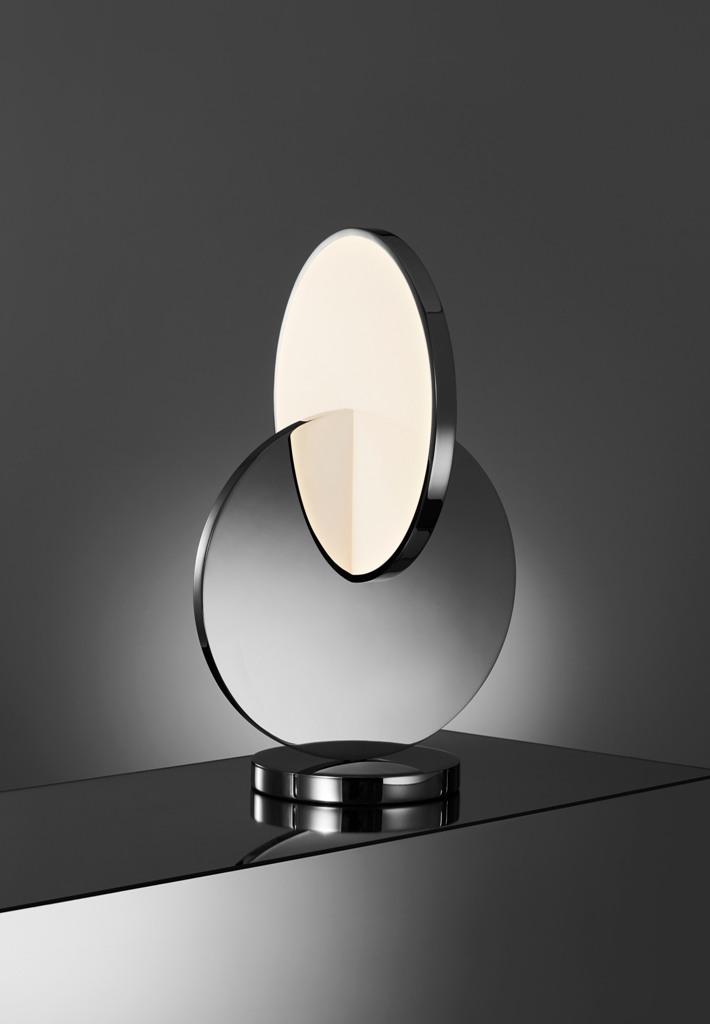Tidal is a table lamp formed from polished chrome and acrylic with LED lights