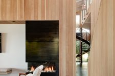 03 The inside of the home is clad with the same light-colored wood as outside, and the color palette is comfortable and earthy