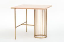 03 The side table is made of brass and pink marble, which is a stylish and sophisticated combo