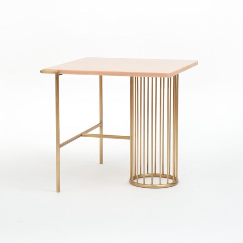 The side table is made of brass and pink marble, which is a stylish and sophisticated combo