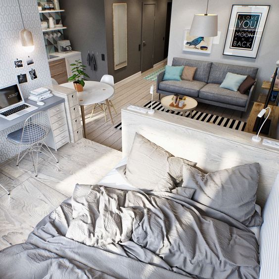 a small studio apartment done in the shades of grey and off-white for a modern feel