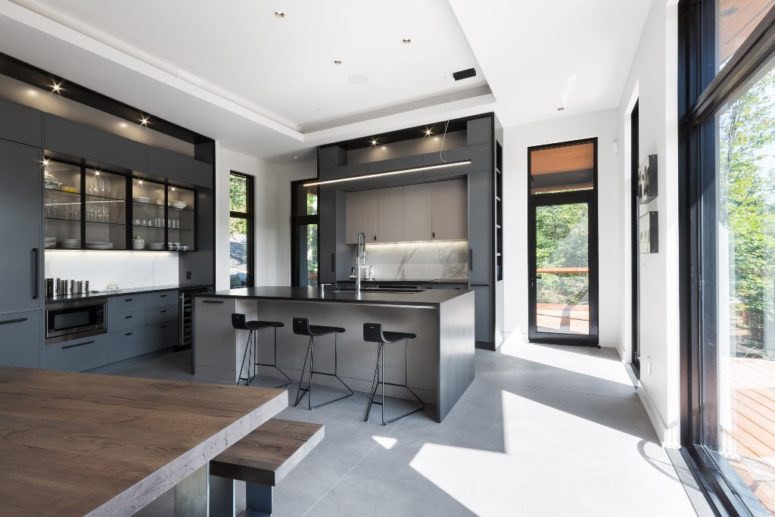 The interiors are minimalist, done with metal, concrete, plywood, in grey, black and white