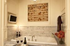 04 a chic and romantic niche with a bathtub clad with grey marble tiles and a backsplash covered with them, too