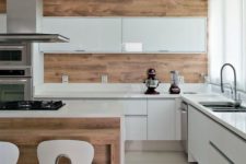 04 a glossy minimalist kitchen in white and rich-colored wood for a more natural feel