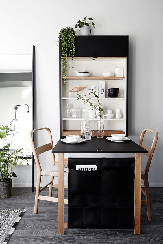 a wall shelving unit with a clesed part perfectly matches the dining set and adds to the decor