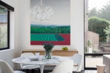 06 Here’s an indoor dining zone with a bold artwork and a marble round table to catch an eye