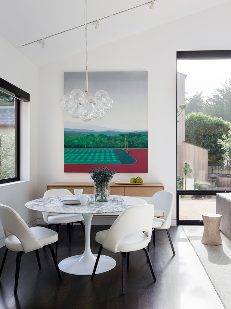 Here's an indoor dining zone with a bold artwork and a marble round table to catch an eye