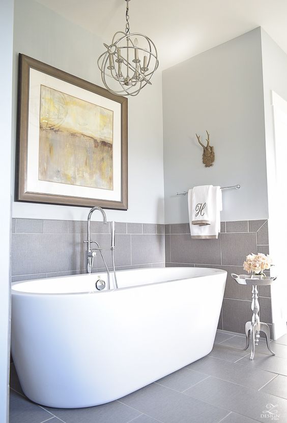 a cozy and elegant bathroom niche done with grey tiles and a modern free-standing tub