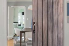06 this sliding barn door with exposed hardware and studs makes a bold statement in a modern space