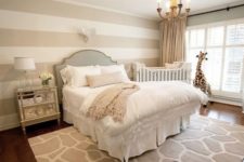 07 a chic space with a glam feel and a crib by the window, a giraffe toy and a rug are matching