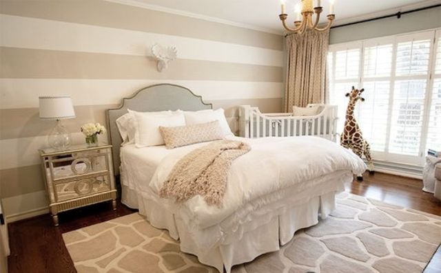 a chic space with a glam feel and a crib by the window, a giraffe toy and a rug are matching