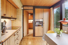 08 The kitchen is a separate room with its own breakfast space, there are wooden cabinets and a glazed wall