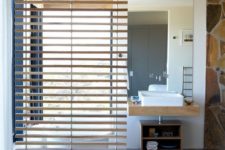 08 a gentle wooden screen separates a bathroom into zones for more privacy and comfort