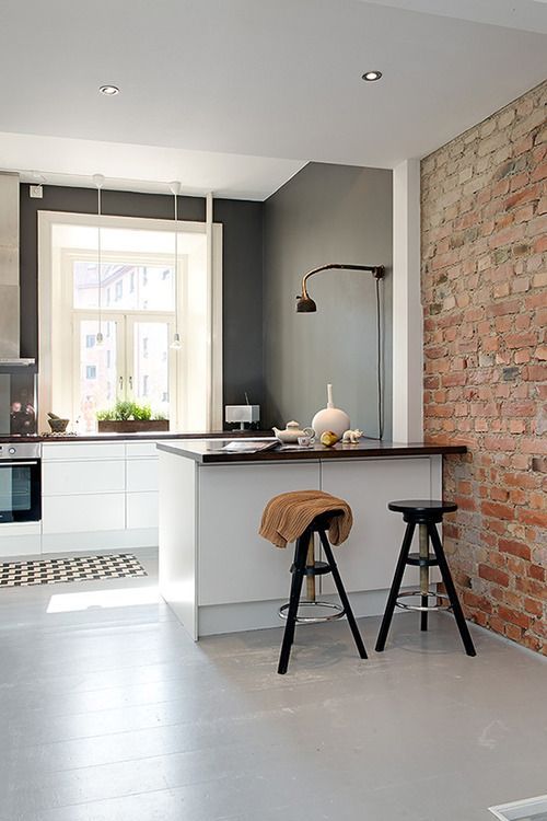 a small contemporary kitchen nook separated from the rest of the space with a kitchen island