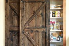 08 hide your built-in pantry with a couple of dark stained barn doors to make the kitchen cozy and welcoming